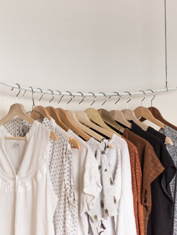 Assorted clothing on wooden hangers