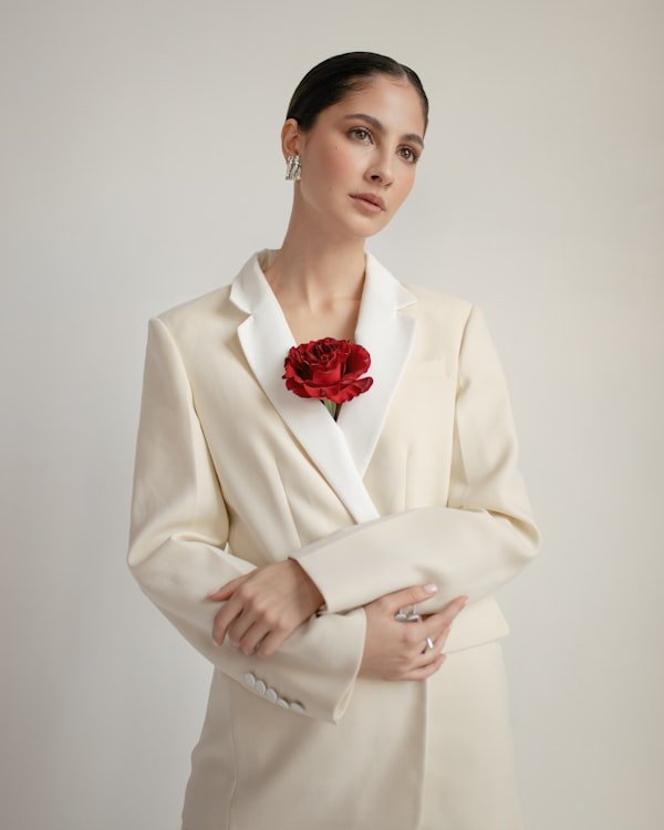 Woman wearing a tailored white blazer from the Astor Lane women's collection